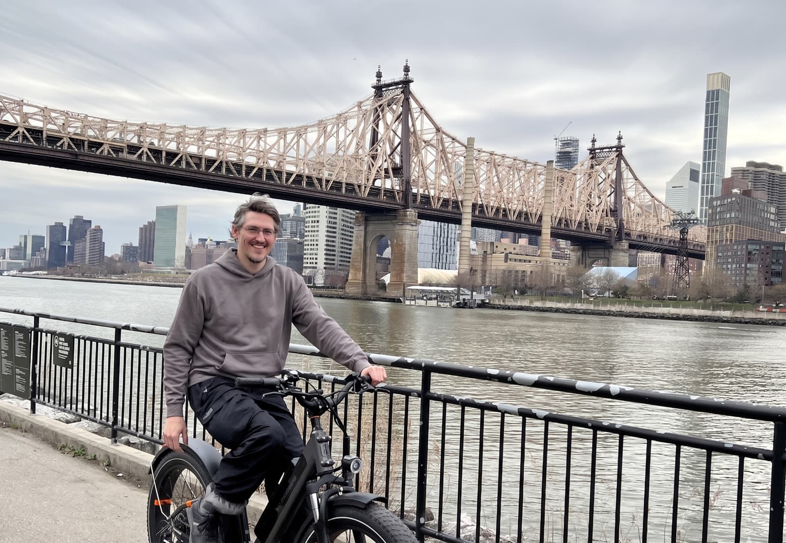Cyclist carrying a Freshly Baked delivery through a rainy neighborhood street